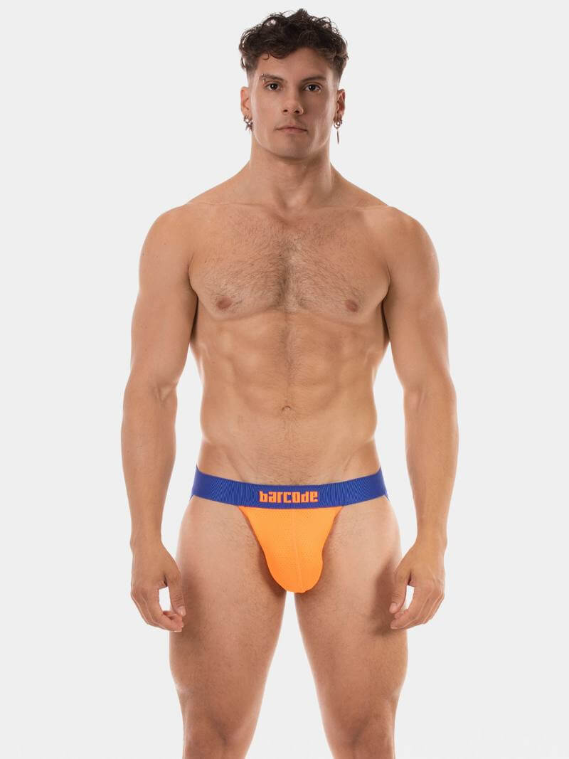 Man wearing orange men's underwear with blue waistband on a white background