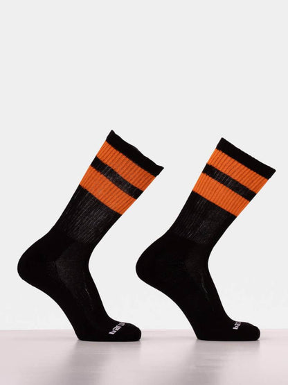 Black socks with orange stripes on a white background