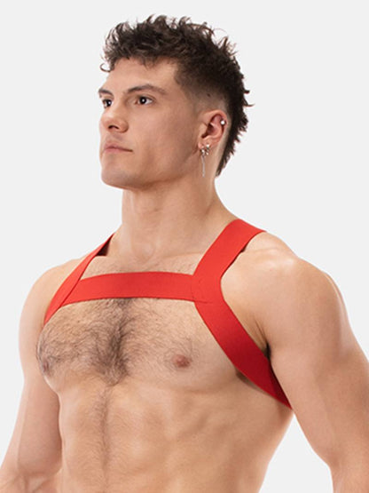 Man wearing a red chest harness against a white background