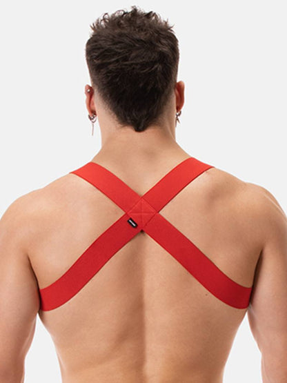 Man wearing a red chest harness against a white background