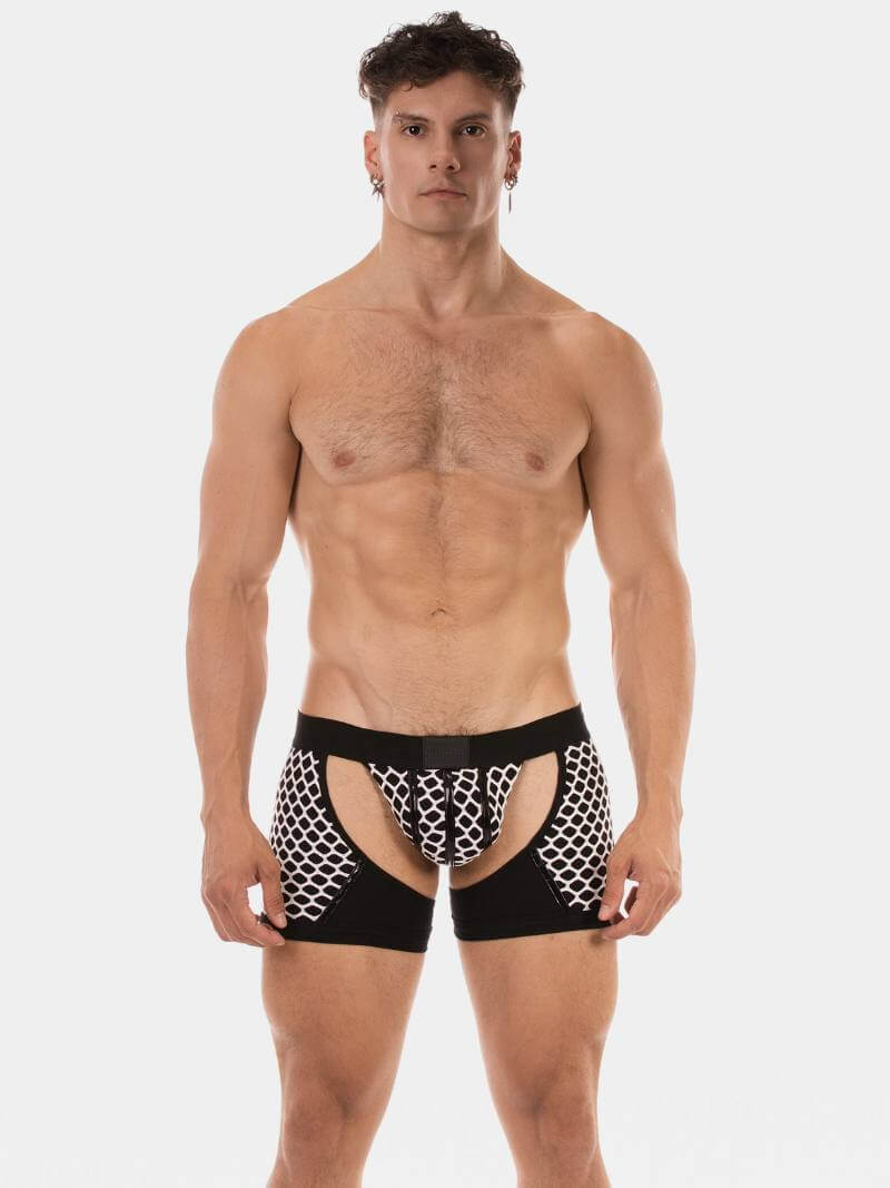 Man wearing black and white patterned underwear on a plain background