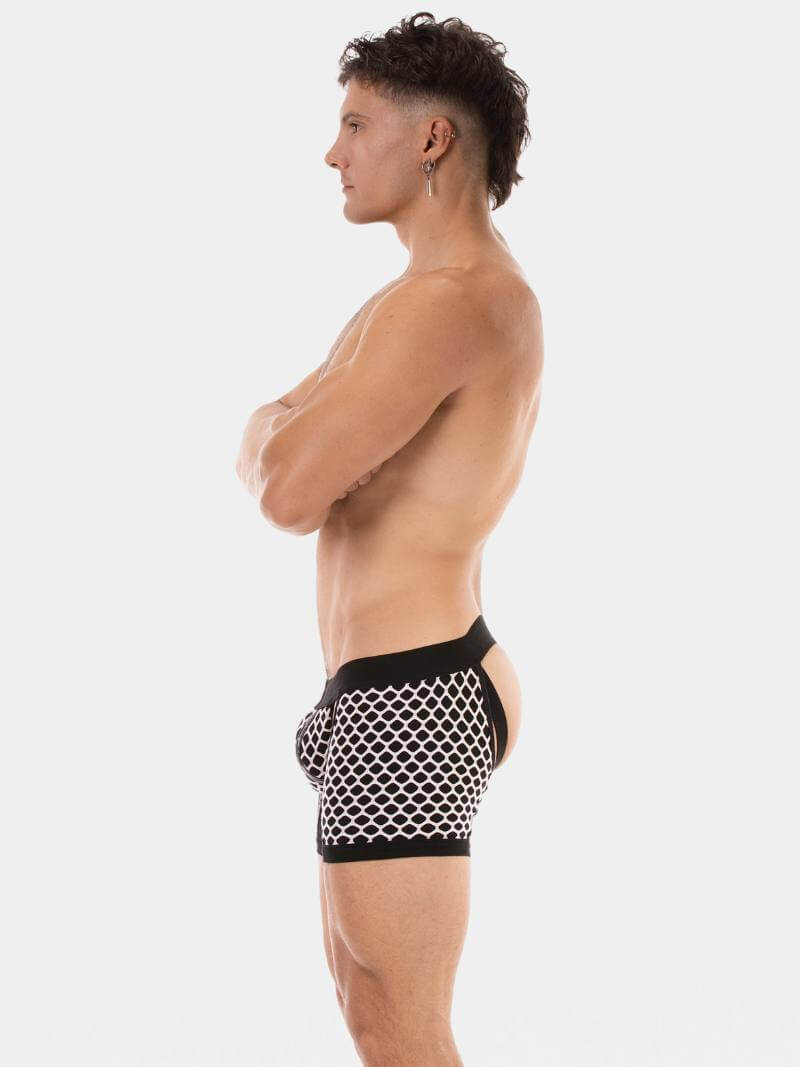 Person wearing black and white patterned swim shorts on a plain background