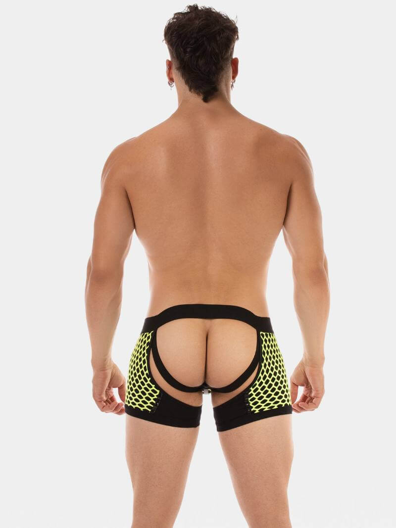 Man wearing a black mesh thong with yellow accents on a white background