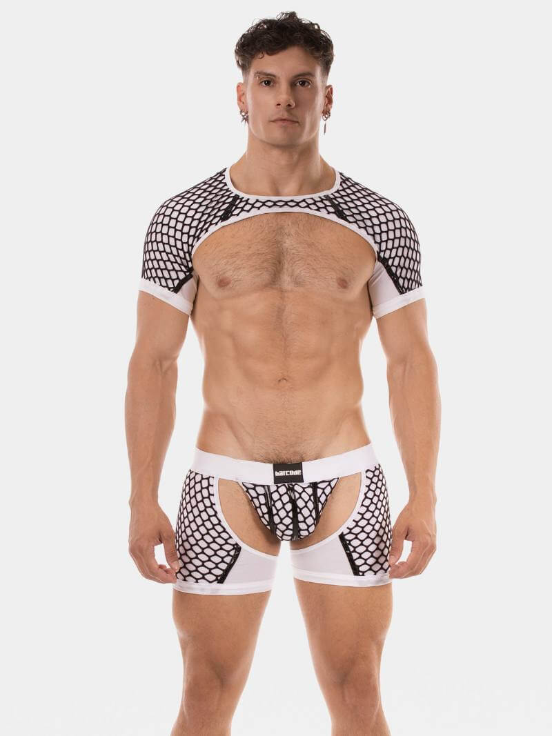 Man wearing a black and white mesh harness on a white background