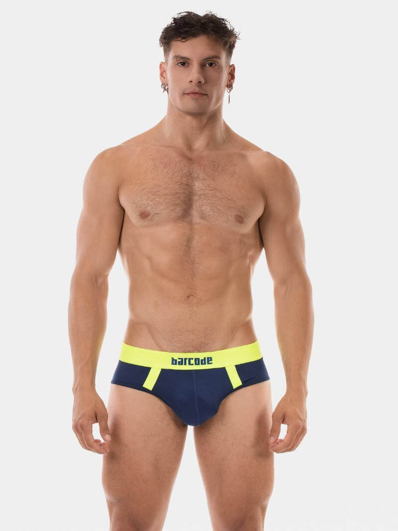 Man wearing a navy and yellow swimsuit with 'Barcode' branding on a white background