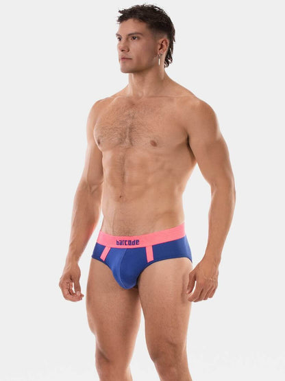 Man wearing blue swim briefs with pink waistband on a white background