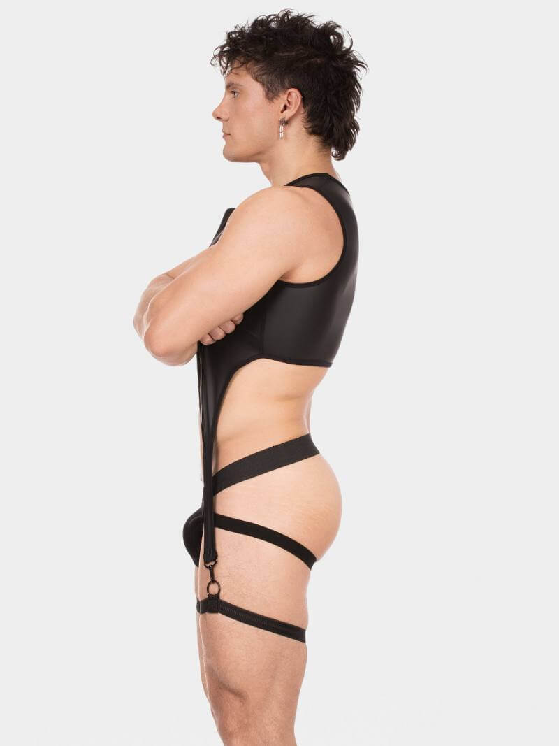 Person wearing a black strappy outfit on a white background