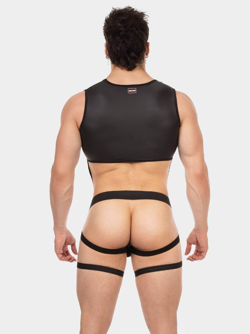 Man wearing a black sports bra and garter belt on a white background