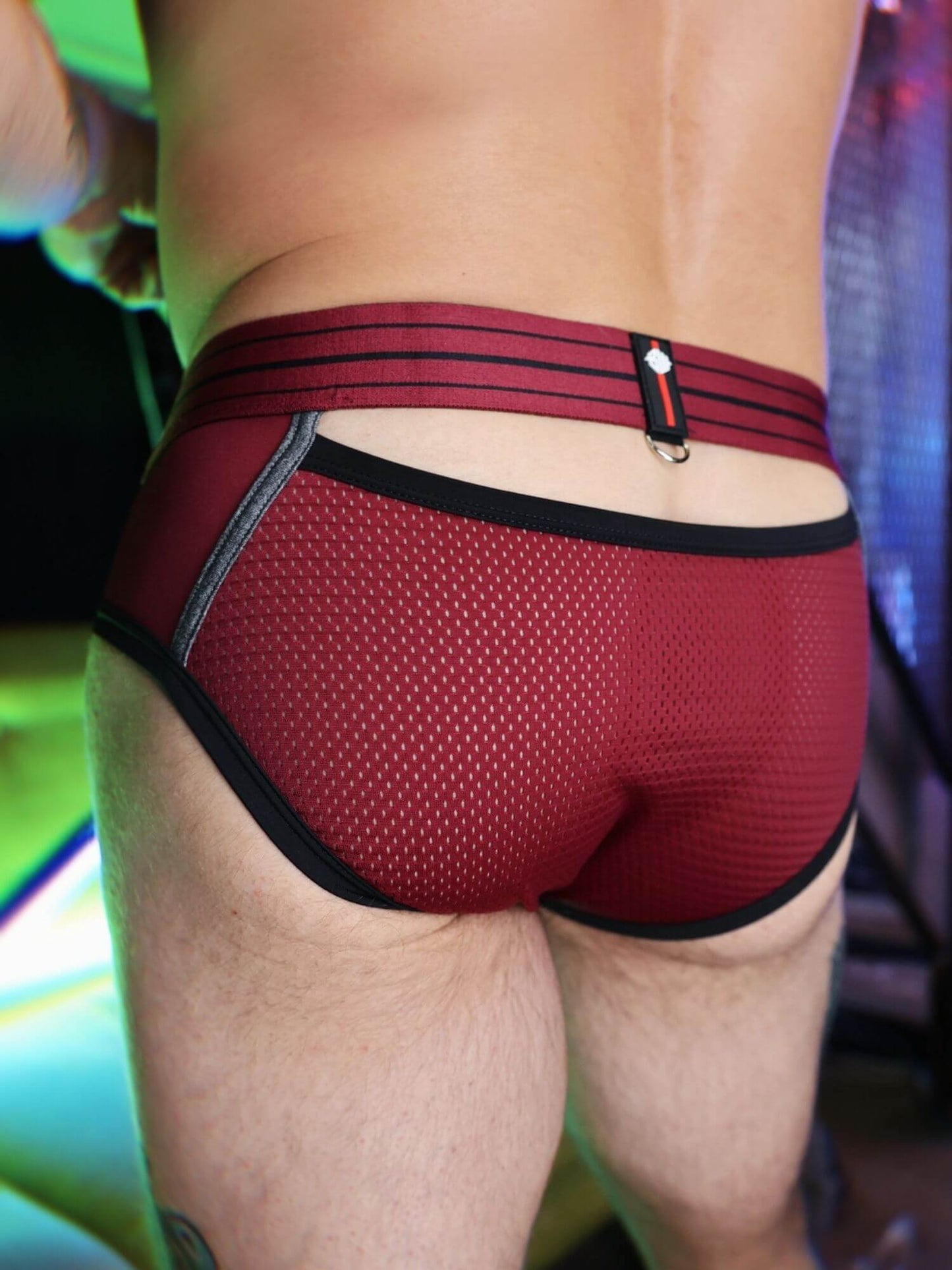 Red men's mesh underwear with black trim on a blurred background