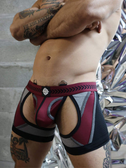 Person wearing a red and black patterned underwear with a visible brand logo.