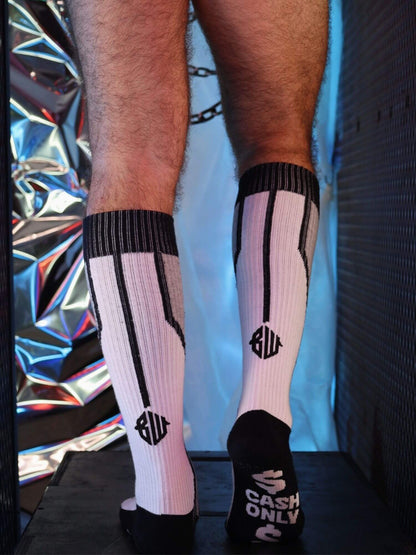 Person wearing grey and black socks with visible branding against a colorful background