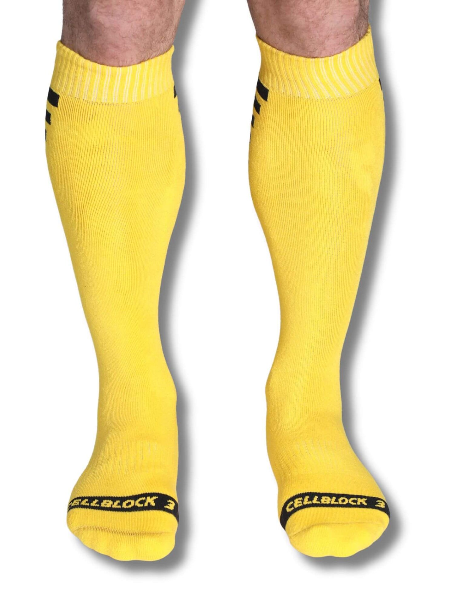 Yellow knee-high socks with black accents on a white background