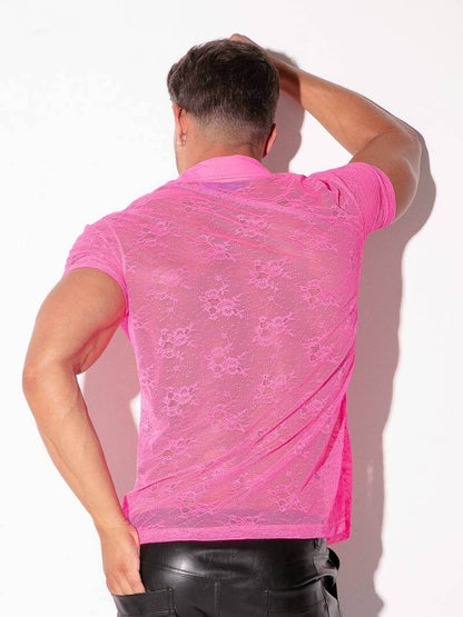 Person wearing a pink lace shirt against a white background