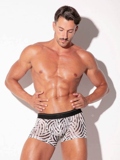 Muscular man wearing zebra print underwear against a white background