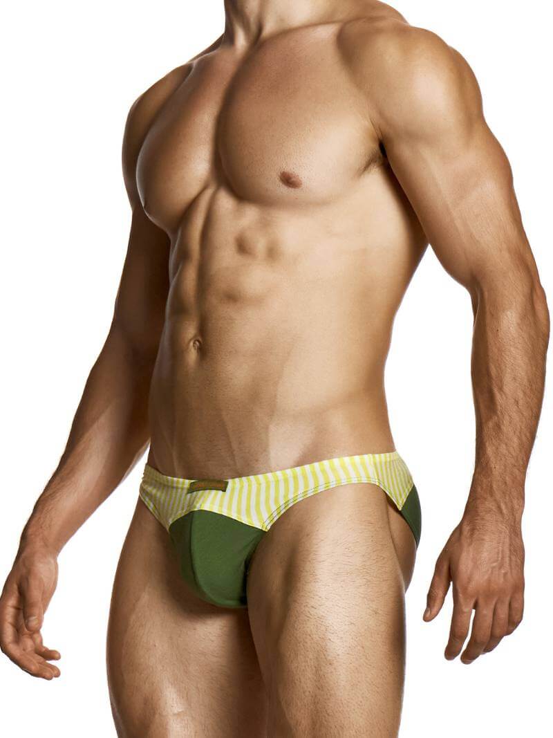 Man wearing a green and yellow striped swim brief on a white background