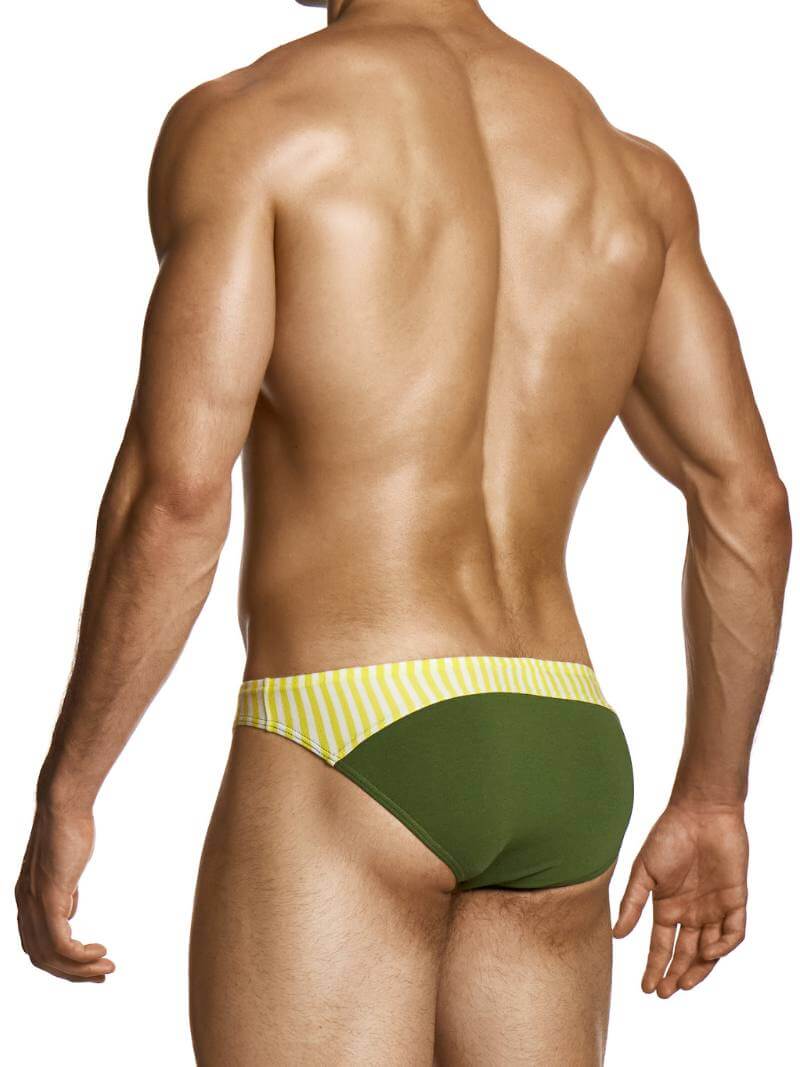 Man wearing green and yellow striped swim briefs on a white background
