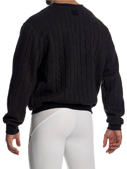 Person wearing a black equestrian jacket and white pants on a white background