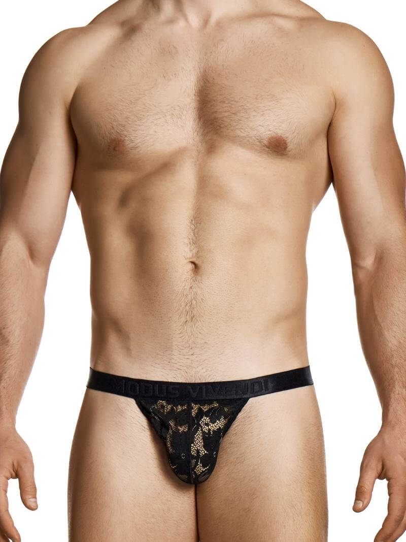 Man wearing a black lace thong on a white background
