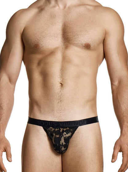 Man wearing a black lace thong on a white background