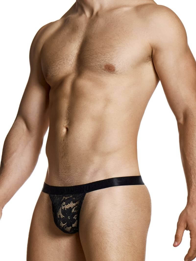 Man wearing a black lace thong on a white background
