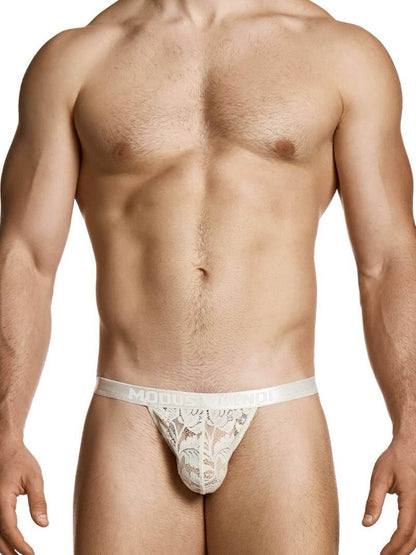 Man wearing a white lace thong on a white background