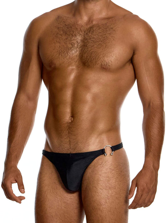 Man wearing a black swim thong on a white background
