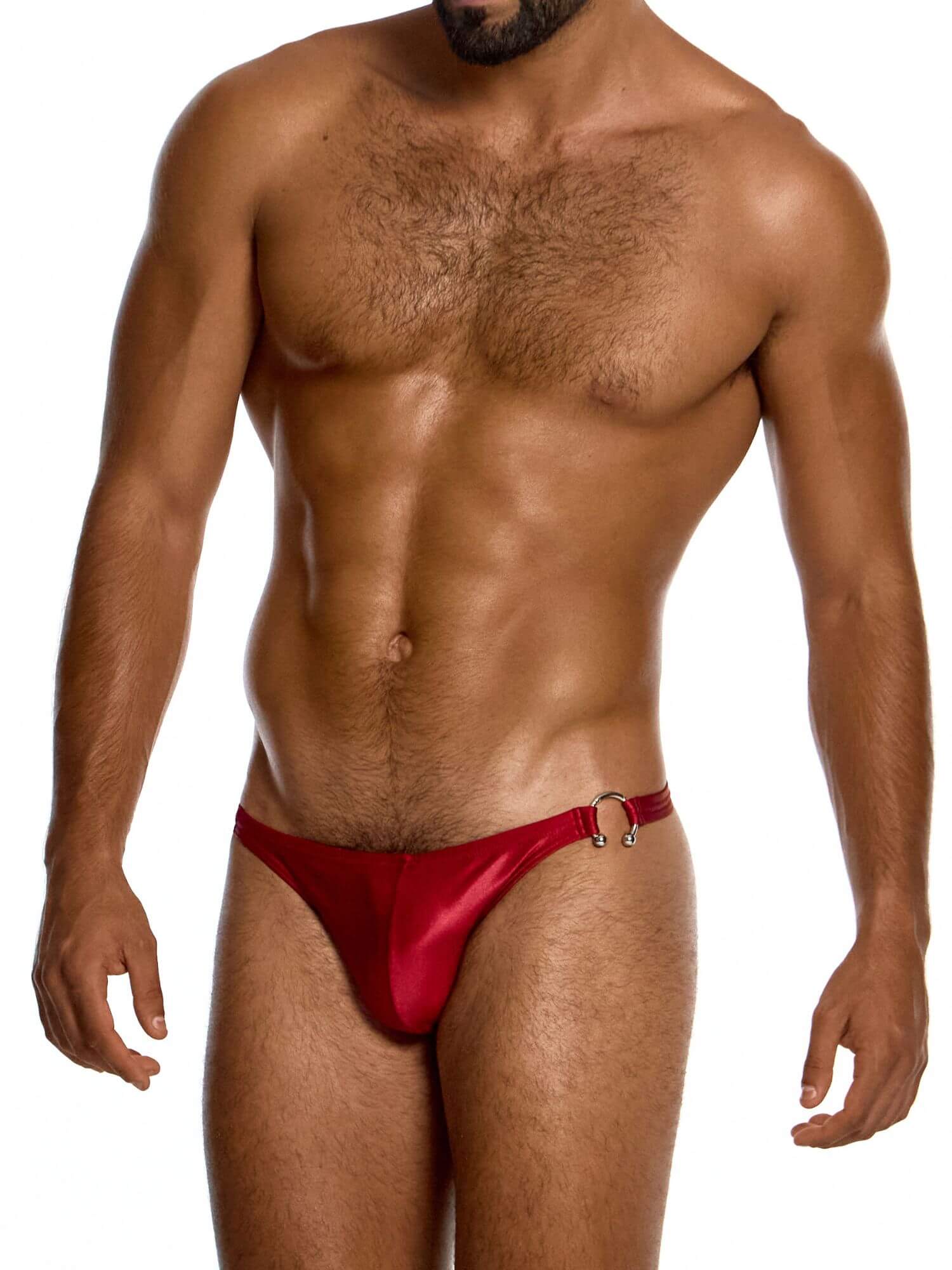 Man wearing a red swim thong against a white background