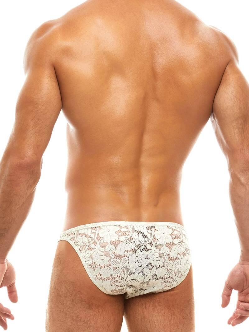 Man wearing a floral lace ivory underwear set on a white background