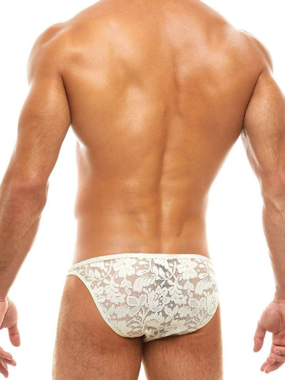 Man wearing a floral lace ivory underwear set on a white background