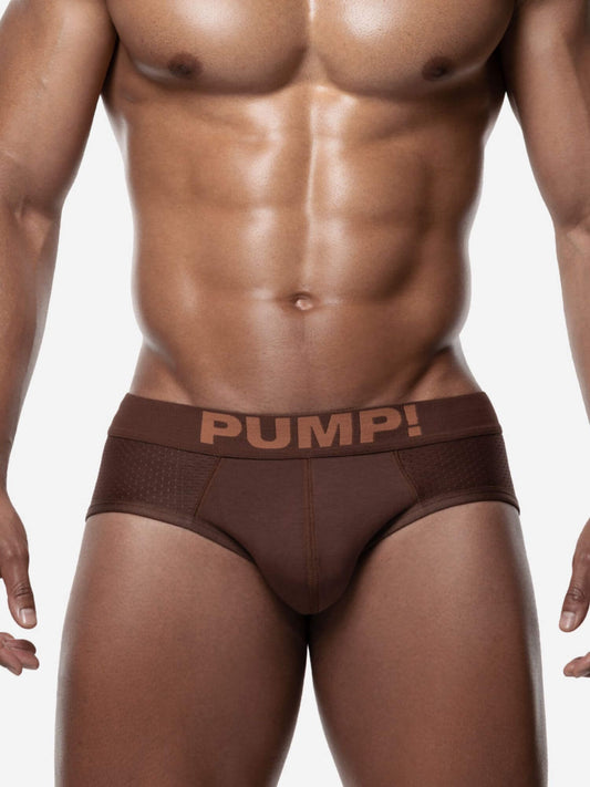 Man wearing brown 'PUMP!' underwear on a white background