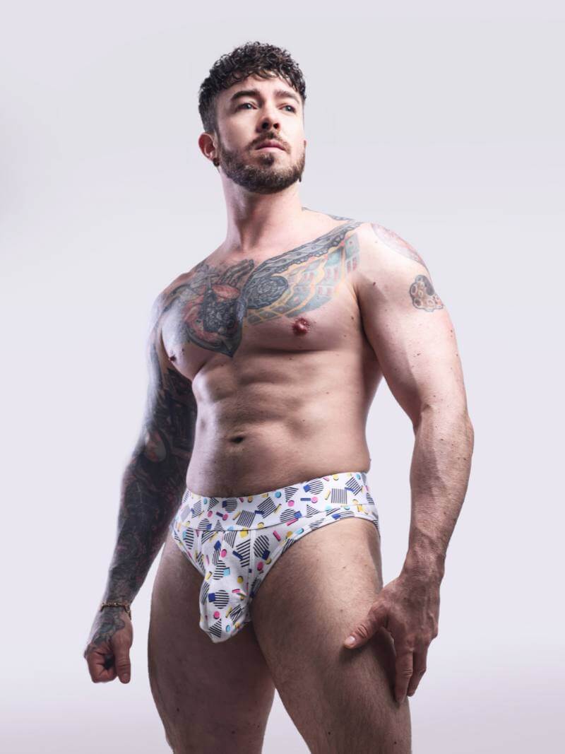 Man wearing colorful underwear against a plain background