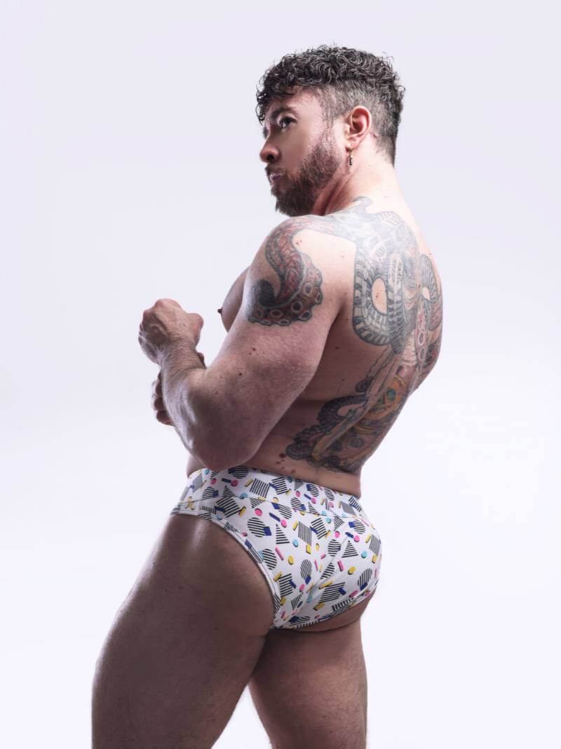 Man wearing patterned underwear against a plain background