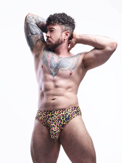 Man wearing colorful leopard print underwear against a white background