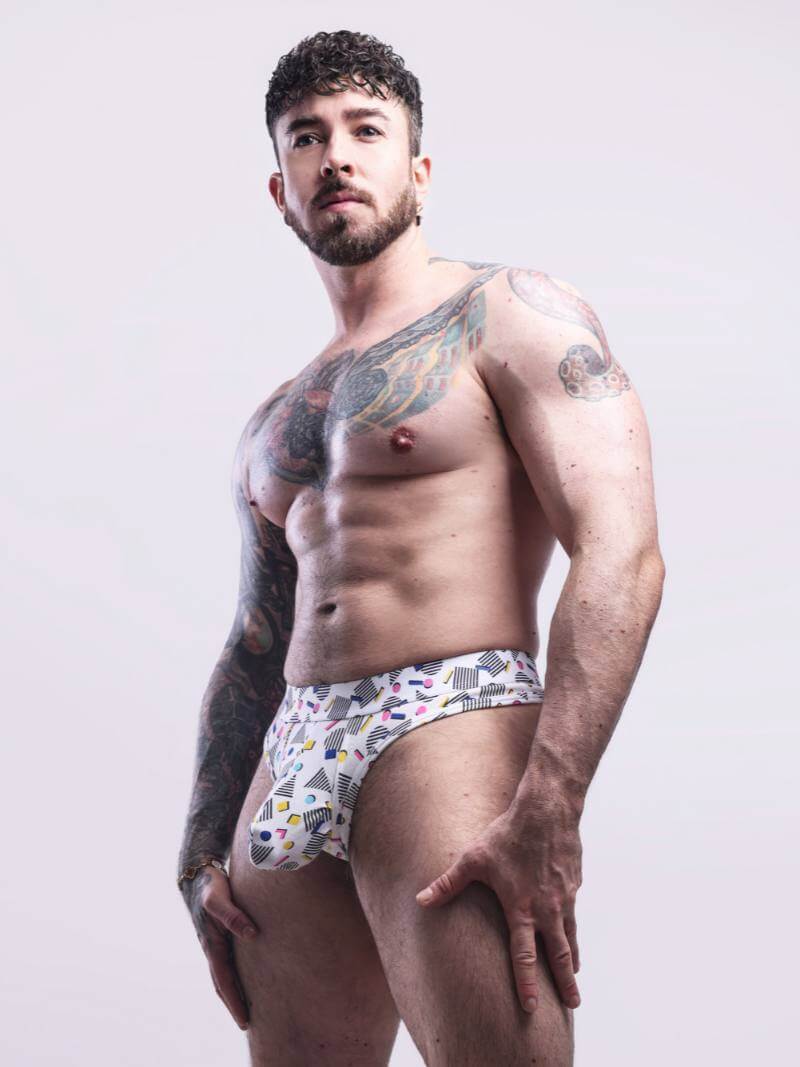 Man wearing patterned underwear against a plain background