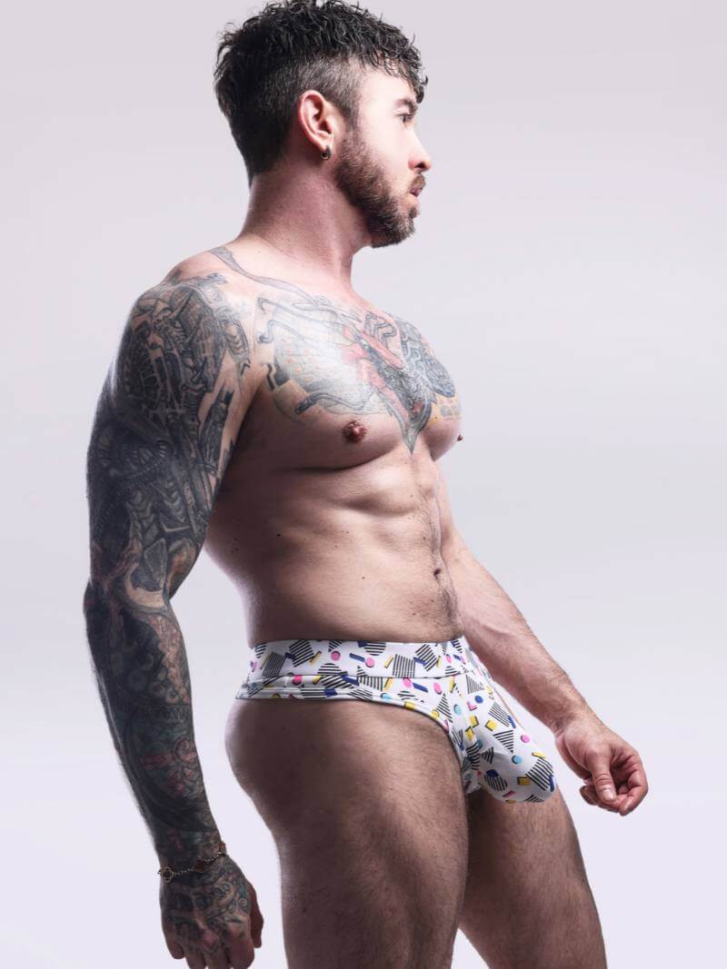 Man wearing patterned underwear against a plain background