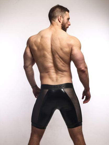 man wearing sukrew men's black wet look boxer briefs with sheer mesh side panels