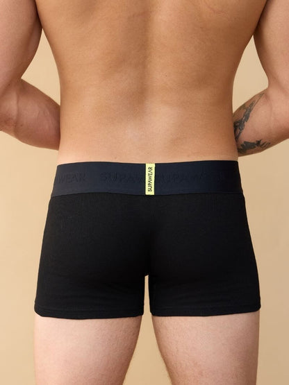 Black boxer briefs with a visible brand logo on a beige background